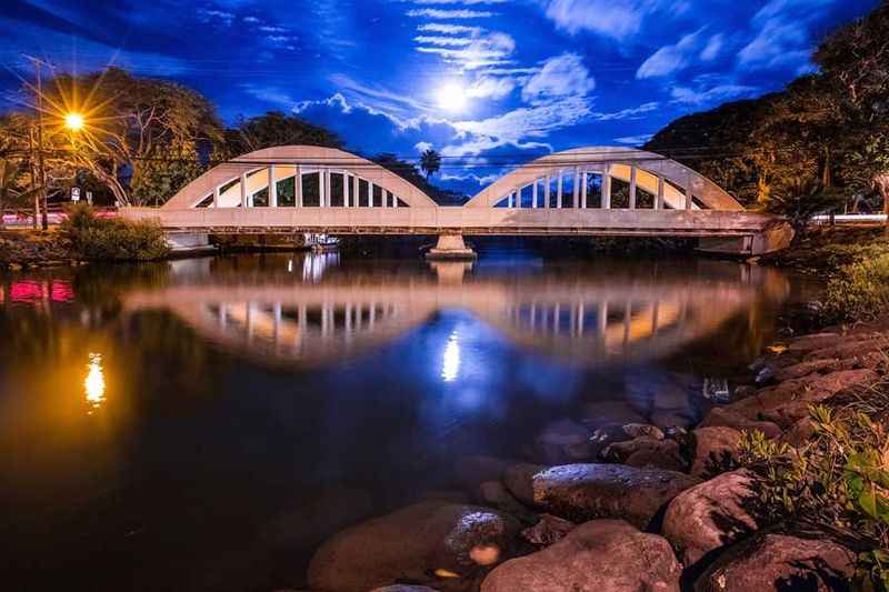 a bridge over a river at night