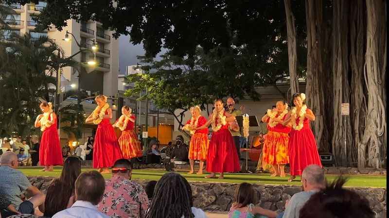 a group of people are performing in a park