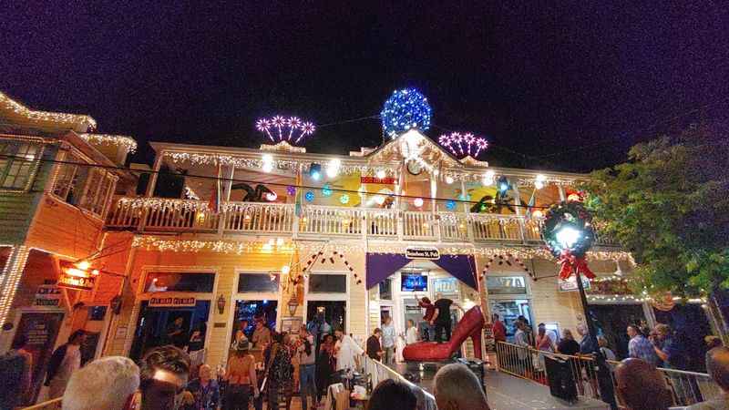 the main street at night with people walking around