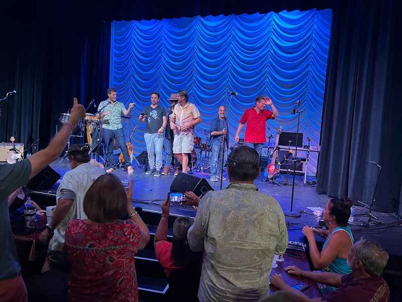 Stage with blue background curtain with singers