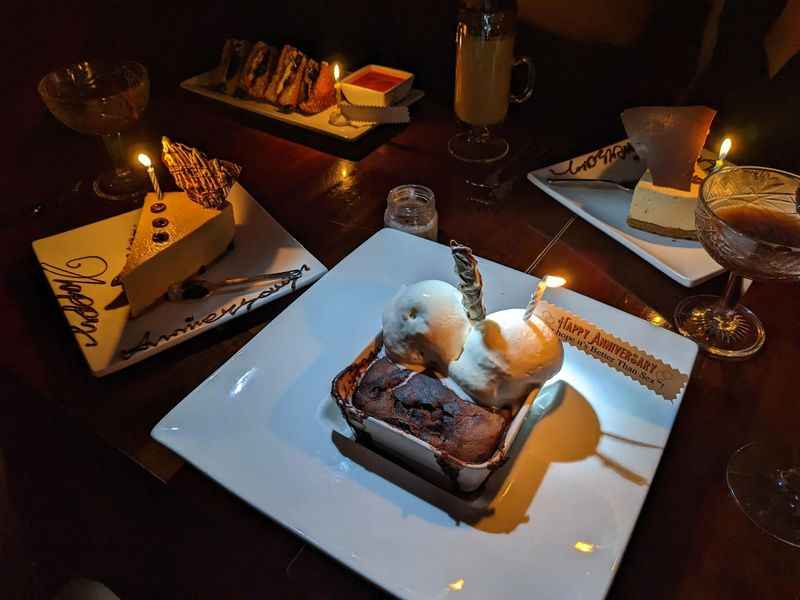 table with variety of dessert with lighted candle