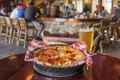 a pizza in a basket on a table