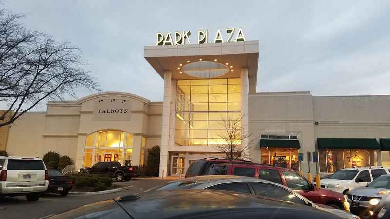 the exterior of a retail center in the evening