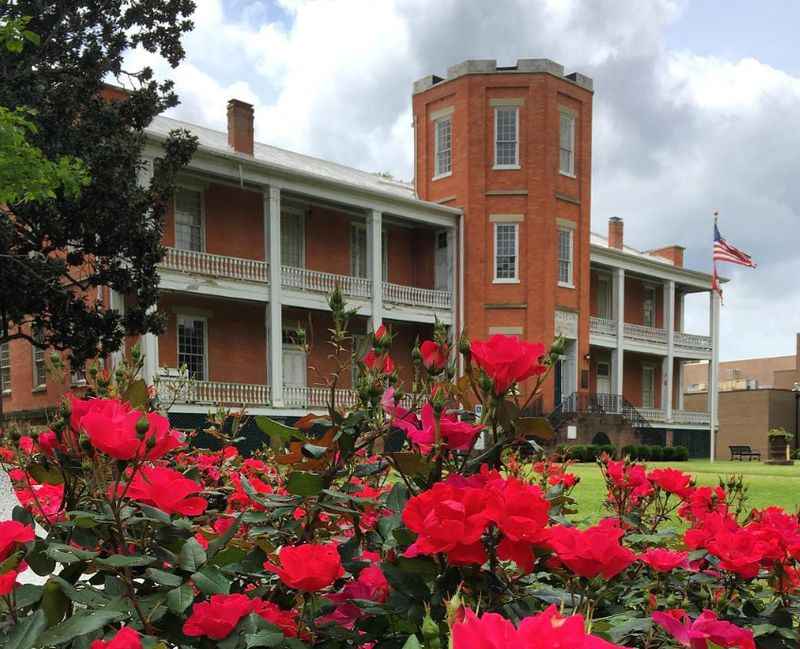 a large brick building with a flag on the top of it