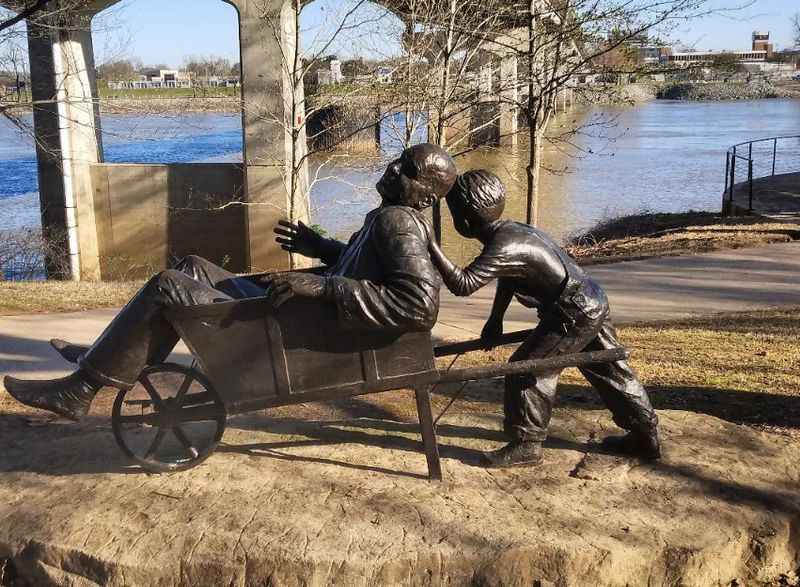 a statue of a man on a horse drawn carriage