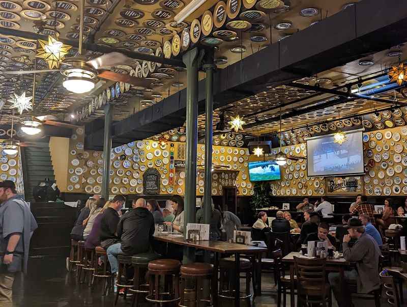 the interior of a restaurant with people sitting at tables