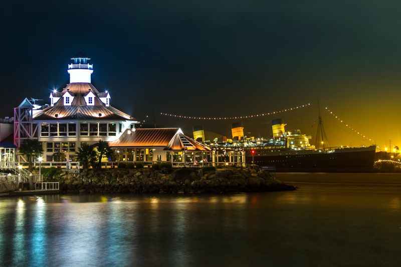 lighted bar at night built beside the ocean 