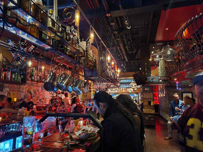 a crowded bar with people sitting at tables