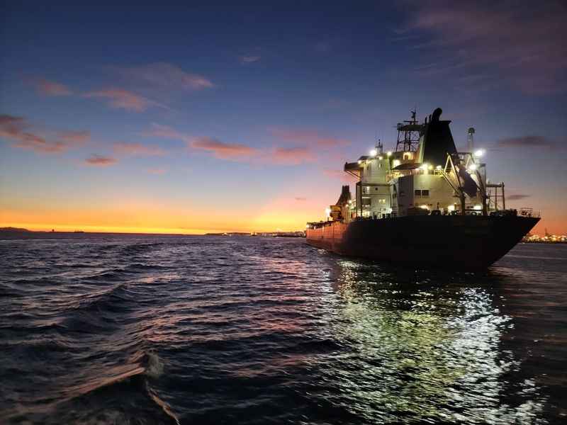 a boat is in the water at sunset