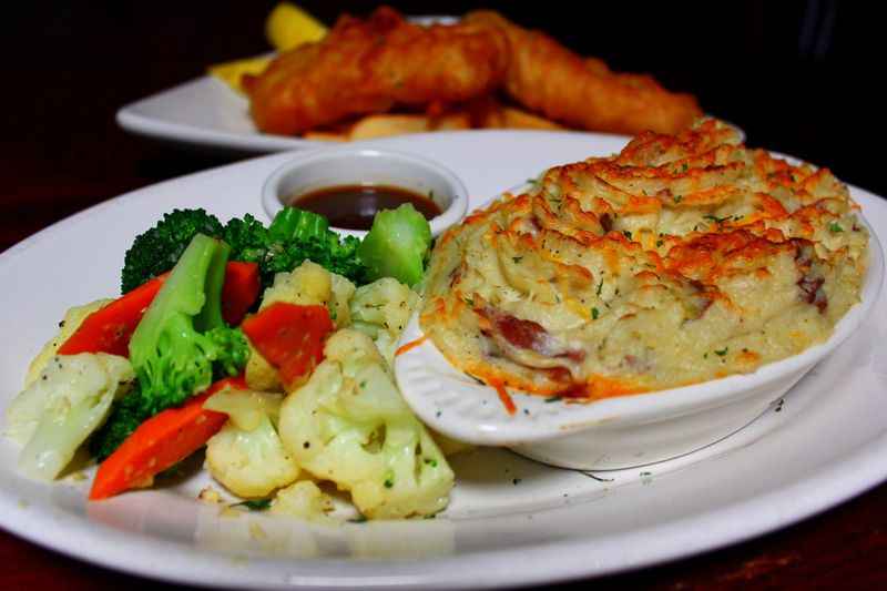 a plate of food with vegetables and bowl of baked pasta