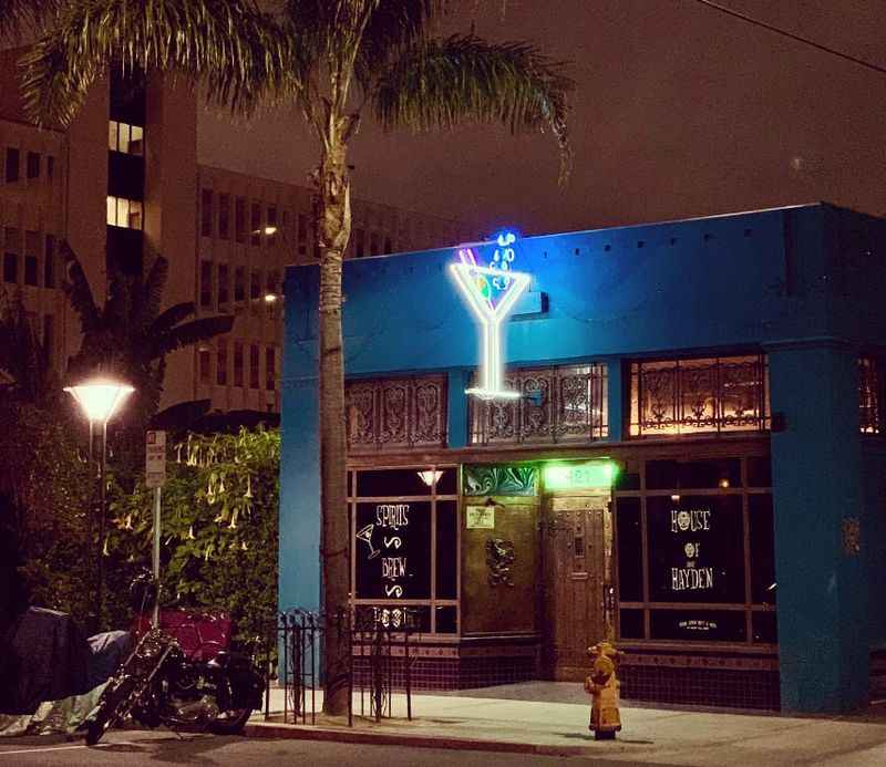 a blue building with a neon sign on it