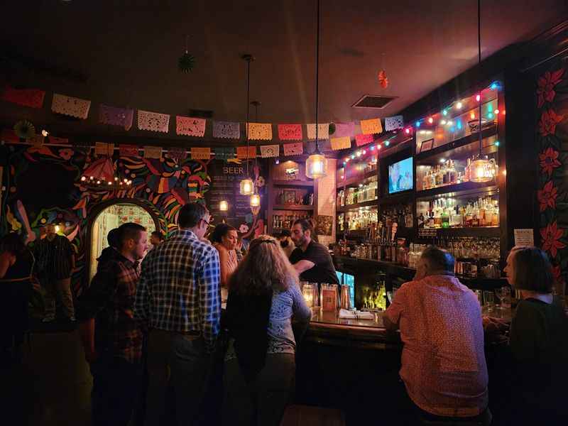 a group of people standing around a bar