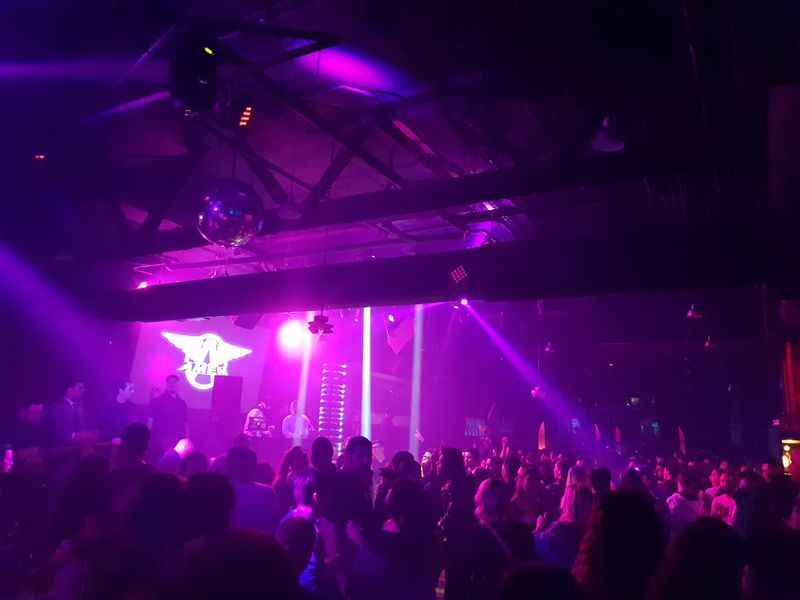 a crowd of people at a concert under the purple lights