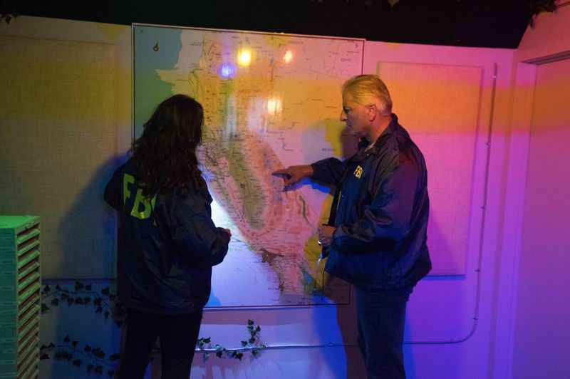 a man and woman standing in front of a map