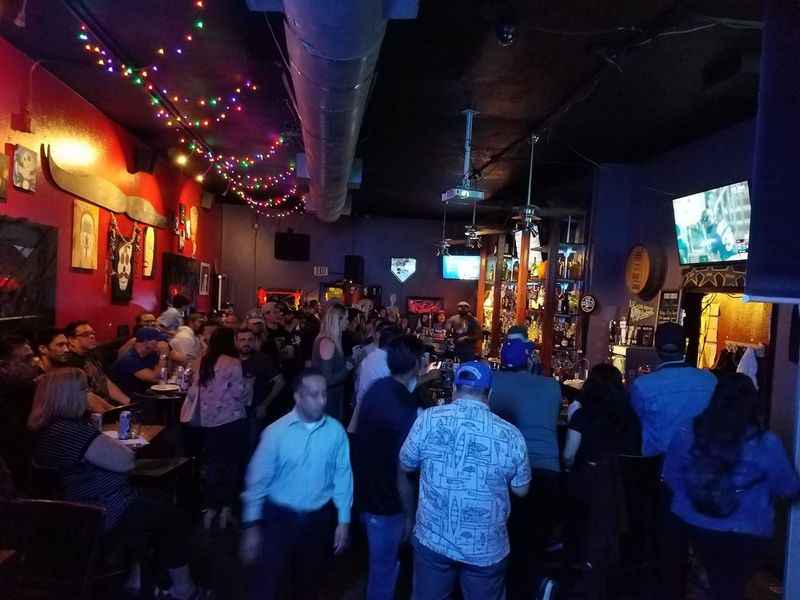 a crowded bar with people sitting at tables