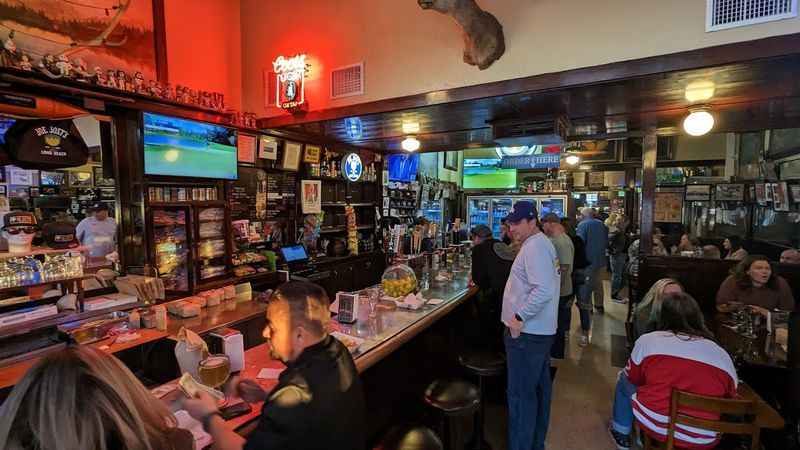 people are sitting at the bar in a restaurant