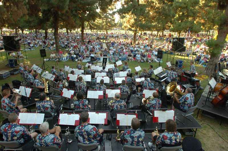 a large orchestra playing in a park
