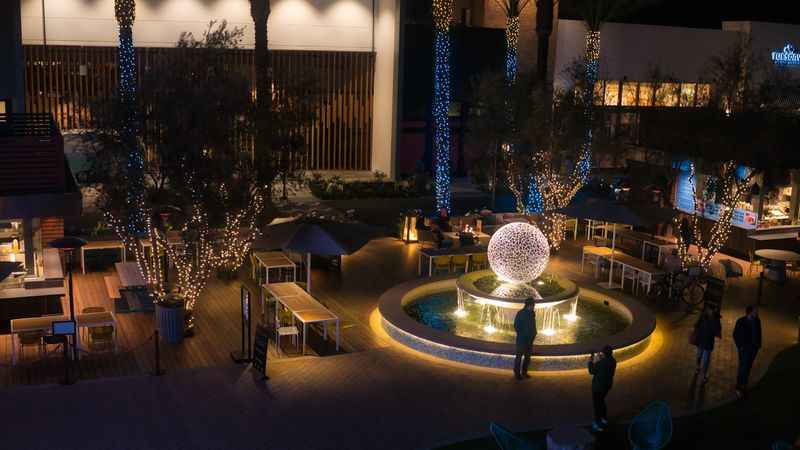 a large white ball in the middle of the fountain with lights