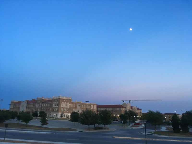 a large building on the side of the road at night