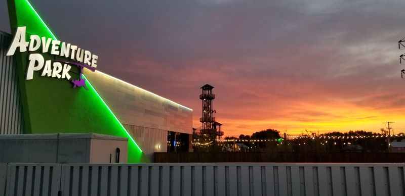 the adventure park sign at sunset