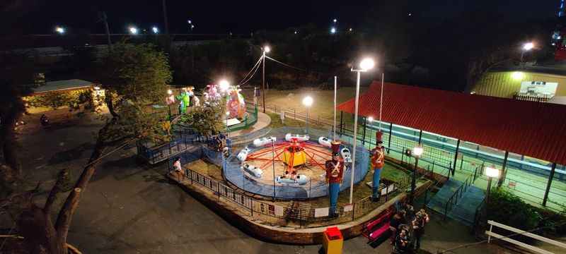 a small carousel at night with people on it