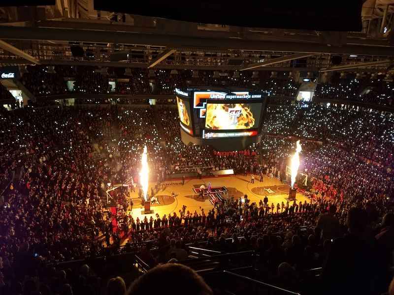 a crowd of people watching a basketball game