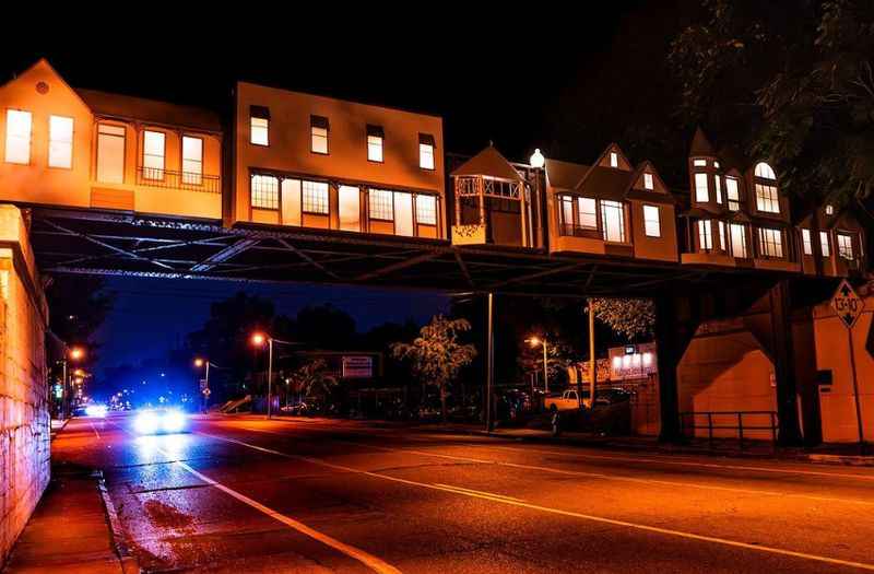 a car is parked under a bridge at night 