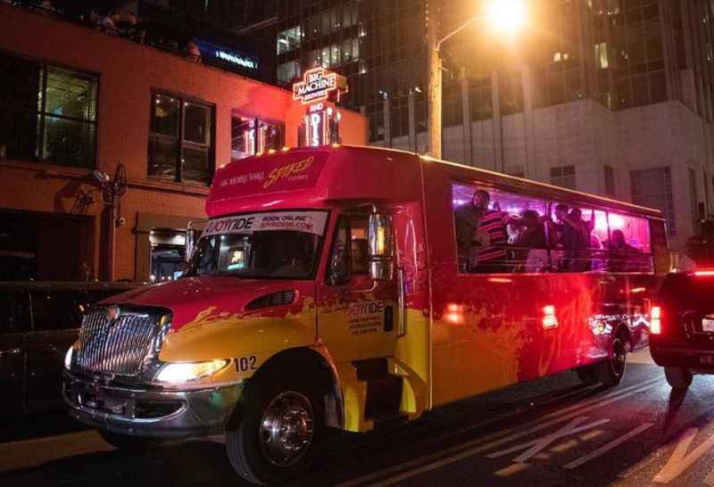 brightly colored bus on a city street at night