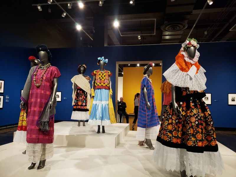 different types of dresses on display in a museum