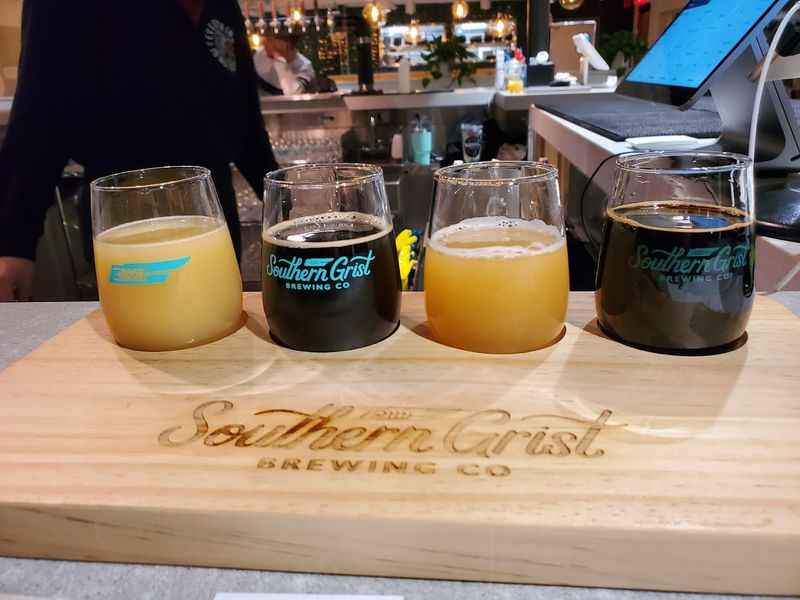 a four glasses of drinks on a cutting board