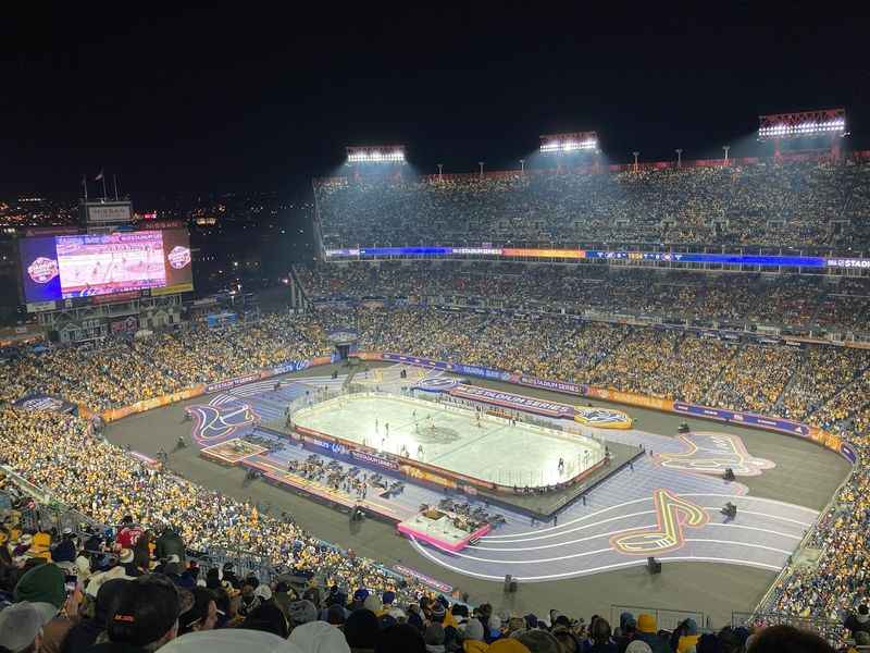  a hockey stadium with a large crowd of people