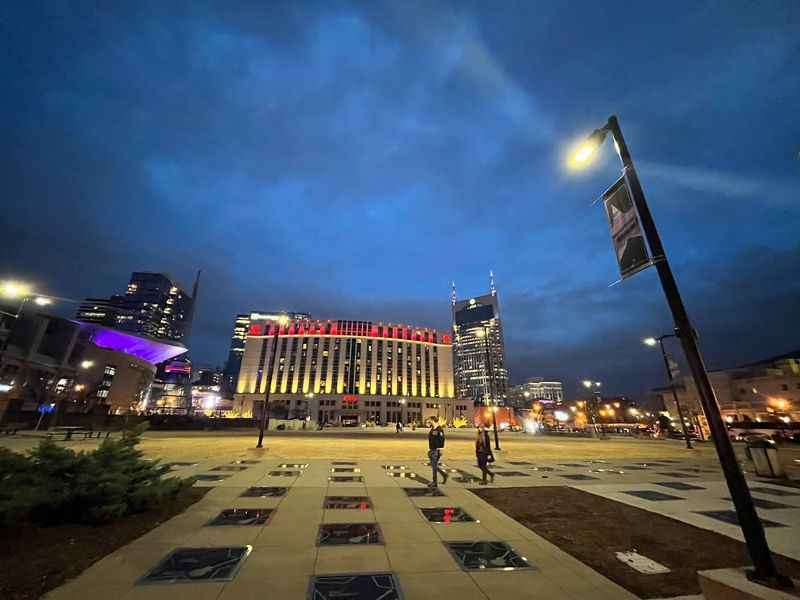 city square with a clock tower and a street light