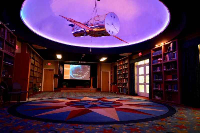 ceiling with a clock and a star pattern in a library