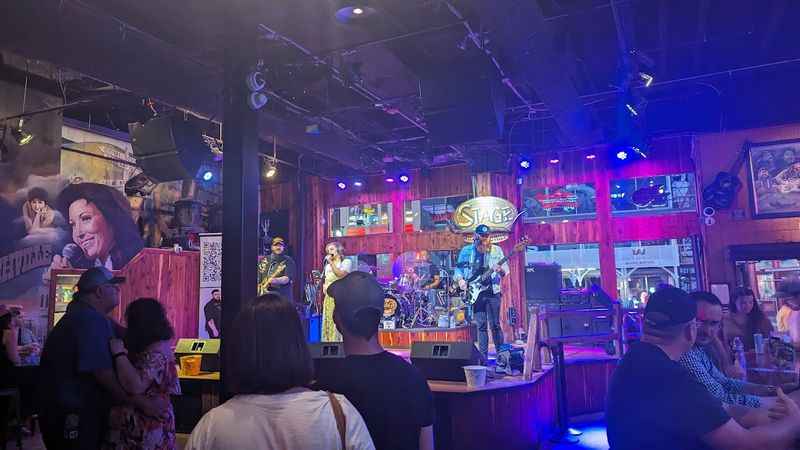 Bar full of people enjoying the music of live band