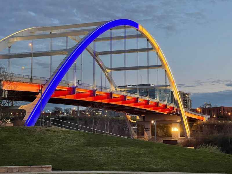 an orange bridge with a blue and yellow arch