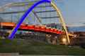 an orange bridge with a blue and yellow arch