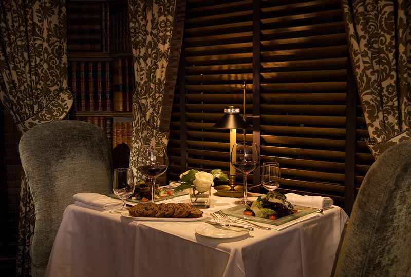 a table with a plate of food and a candle