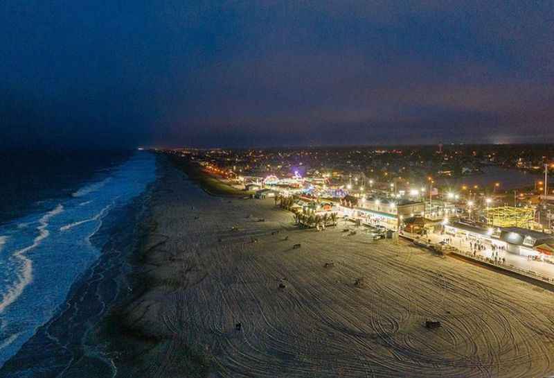 different ligts from houses near the beach at night