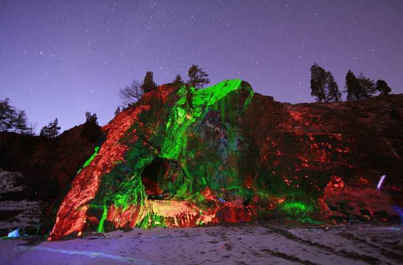 a rock covered in green and red lights