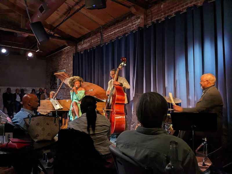 people are sitting in chairs watching a jazz band perform