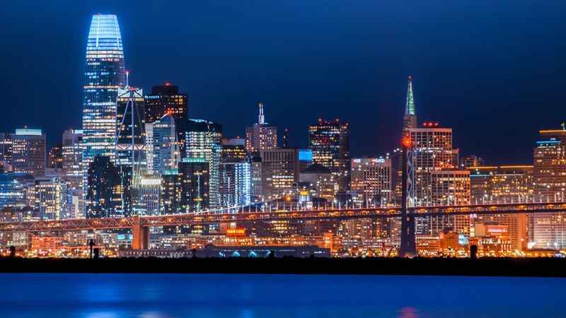 beautiful view of a city at night with a bridge