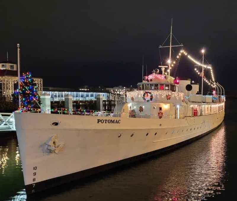 cruise with Christmas lights on it docked in a harbor