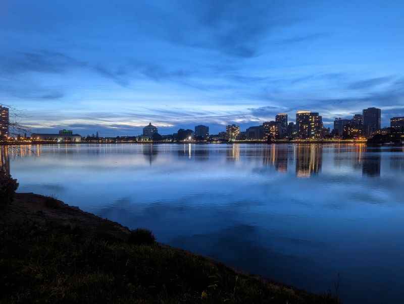 skyline at night with a lake in the foreground