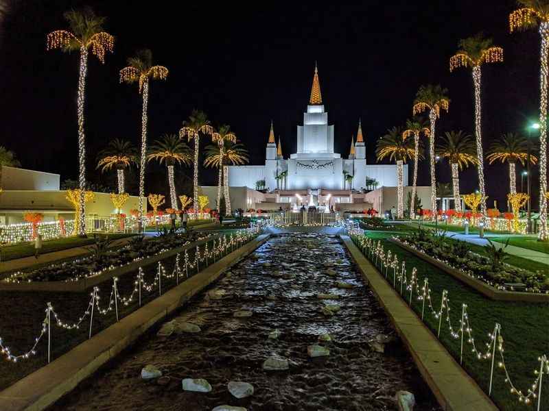 view of a white temple with a fountain in front