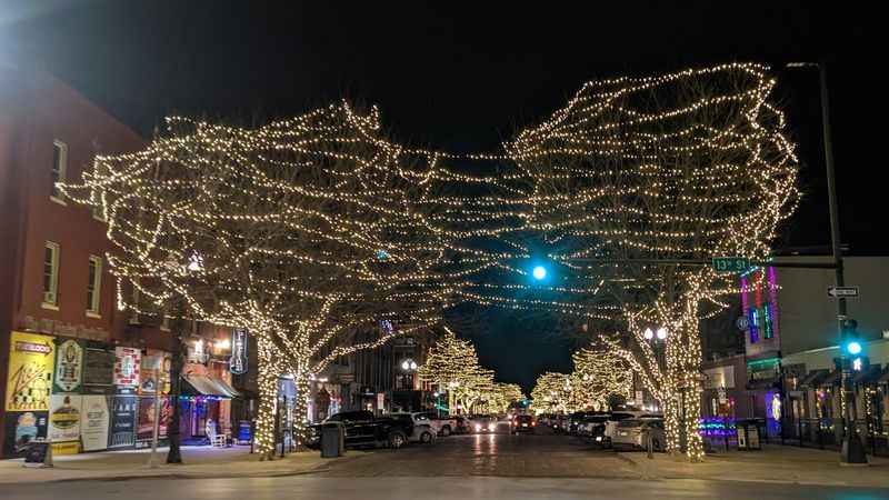 a street with a bunch of lights on the tree