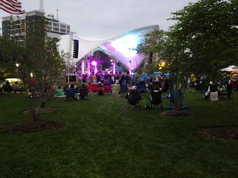 a crowd of people sitting on the grass