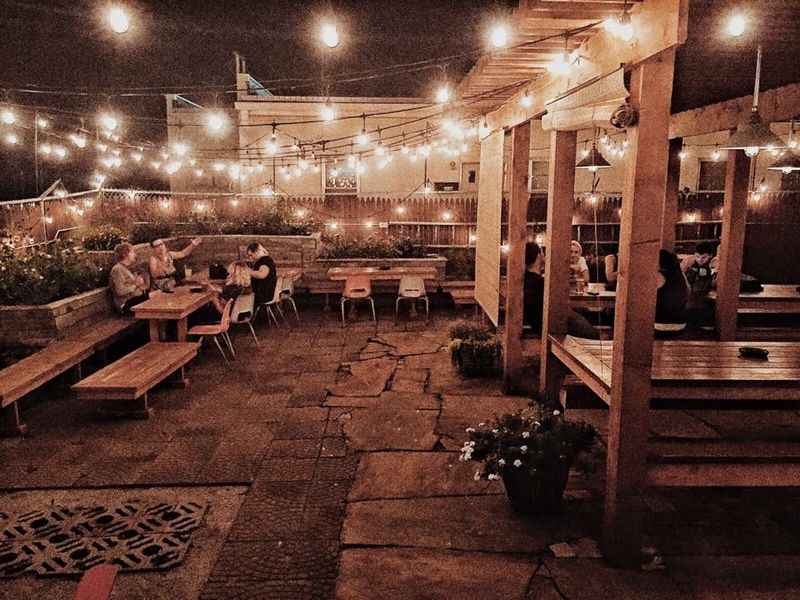 a patio with lights strung over it