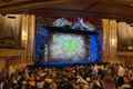 a large crowd of people sitting in a theater