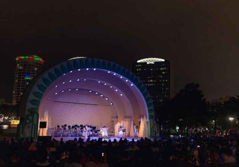 a crowd of people sitting in front of a stage