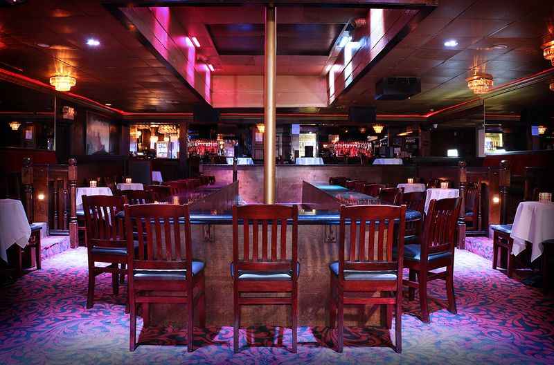 a restaurant with a table and chairs